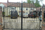 archtop gate including house name and gauntlet motif